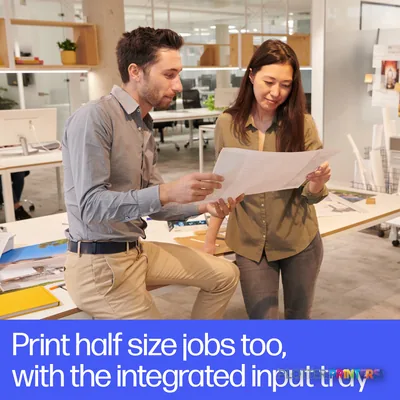 Two professionals reviewing a large printed document in an office, with the HP DesignJet XT950 36-in printer visible in the…