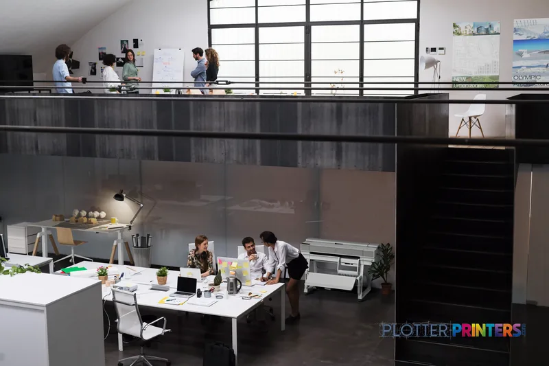 HP DesignJet XT950 36-in white printer in a modern office workspace with team collaborating