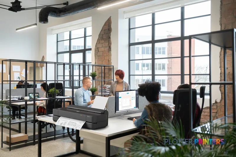 HP DesignJet XT950 36-in printer in a modern office workspace with printed documents on the output tray