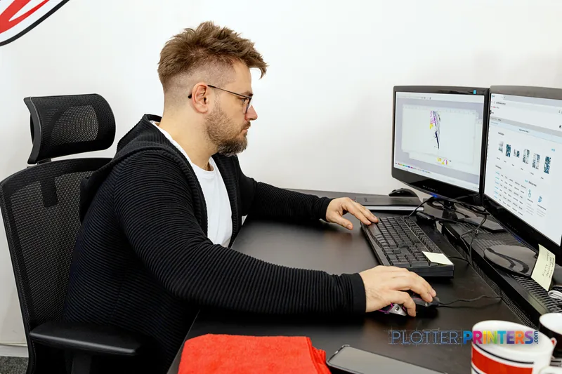 Man at desk using design software with HP Latex 630 Print and Cut Plus Solution lifestyle image