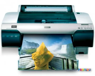 Epson Stylus Pro 4450 large-format printer with grey and silver finish, shown printing a vibrant landscape photo
