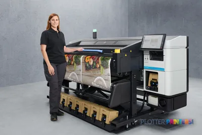 Woman standing beside HP Latex R530 Printer lifestyle image showing colorful fabric print output