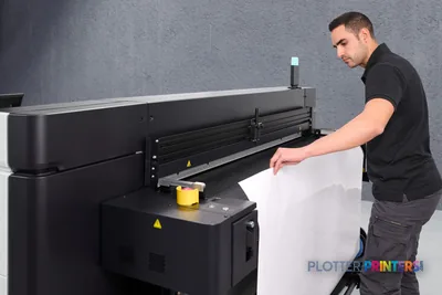 Man loading large-format media into HP Latex R530 Printer in lifestyle setting