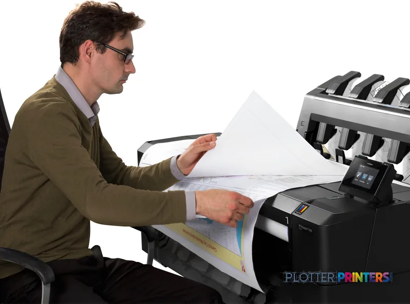 Man examining a large printed technical drawing from the HP Designjet T1500 36-in PS ePrinter in a lifestyle setting