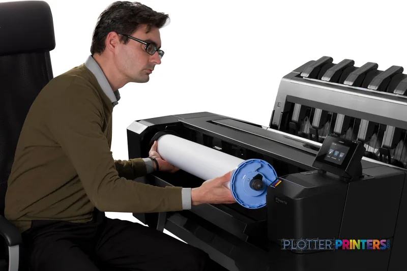 Man loading paper roll into HP Designjet T1500 36-in PS ePrinter large format printer lifestyle image