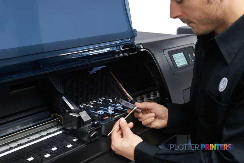 HP Designjet Z6600 lifestyle image showing a technician accessing the printer's ink cartridge system