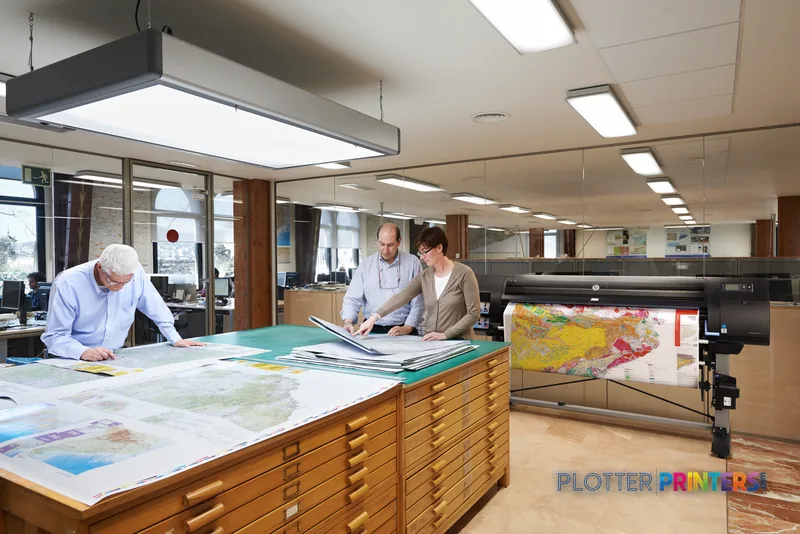 HP Designjet Z6800 large format printer in a professional office setting with staff reviewing printed maps