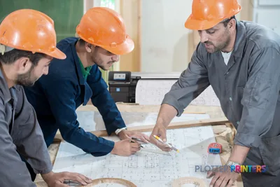 HP DesignJet T830 large-format printer in construction site lifestyle setting with workers reviewing blueprints