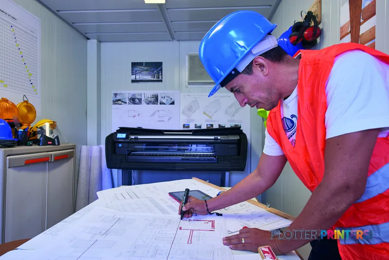 HP DesignJet T830 36-inch printer lifestyle image showing construction worker reviewing large-format blueprints