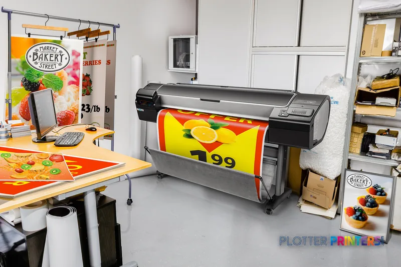HP Designjet Z5600 44-in PostScript printer in a bakery studio, printing colorful signage with fruit imagery