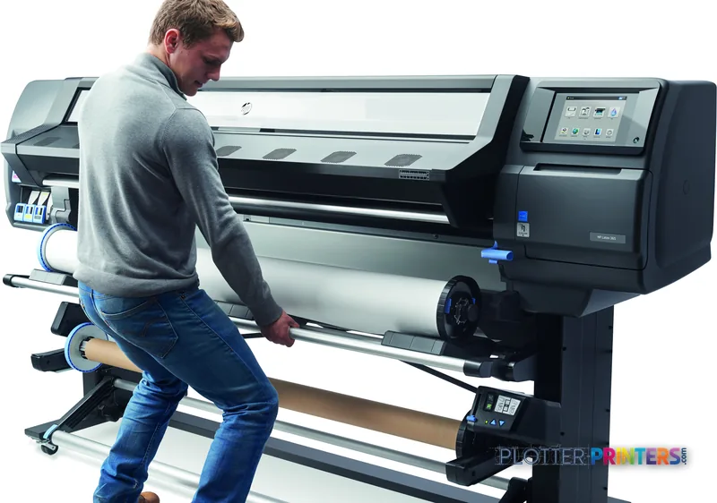 Man operating the HP Latex 365 Printer large-format printer, loading media into the grey printer in a lifestyle setting