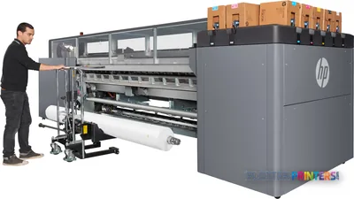 HP Latex 3600 Printer lifestyle image showing operator loading media into the large-format printer