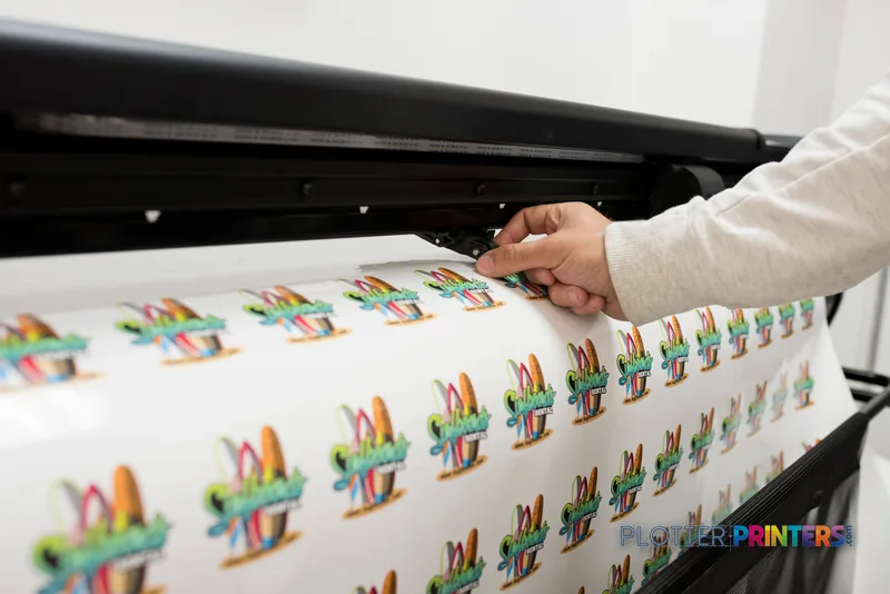 HP Latex 335 Print and Cut Solution lifestyle image showing colorful printed designs being handled during operation