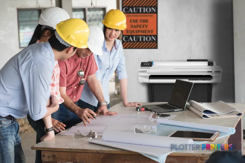 HP DesignJet T130 24-in Printer lifestyle image showing construction professionals reviewing large-format prints at a worksi…