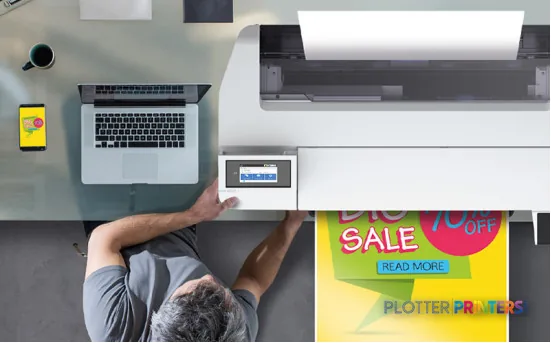 Epson SureColor SC-T3100x large-format printer product image showing overhead view with operator and laptop