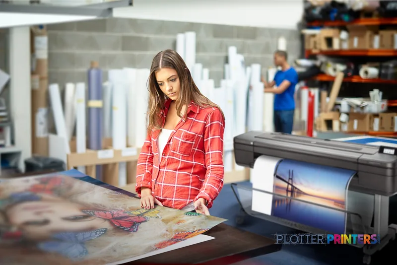 HP DesignJet Z9+ 24-in PostScript Printer lifestyle image showing woman examining large-format print output in studio