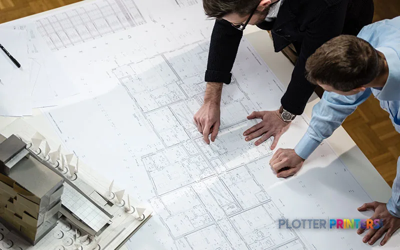 Epson SureColor SC-T3405N large format printer with two people reviewing printed architectural blueprints
