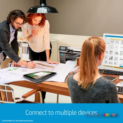 HP DesignJet T830 24-in Multifunction Printer in an office with team reviewing large-format prints