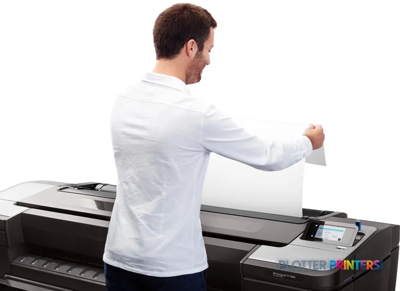 Man pulling a large-format print from HP DesignJet T1700 44-in PostScript Printer in lifestyle setting