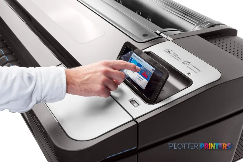 HP DesignJet T1700dr 44-in PostScript Printer lifestyle image showing a user's hand operating the touchscreen display