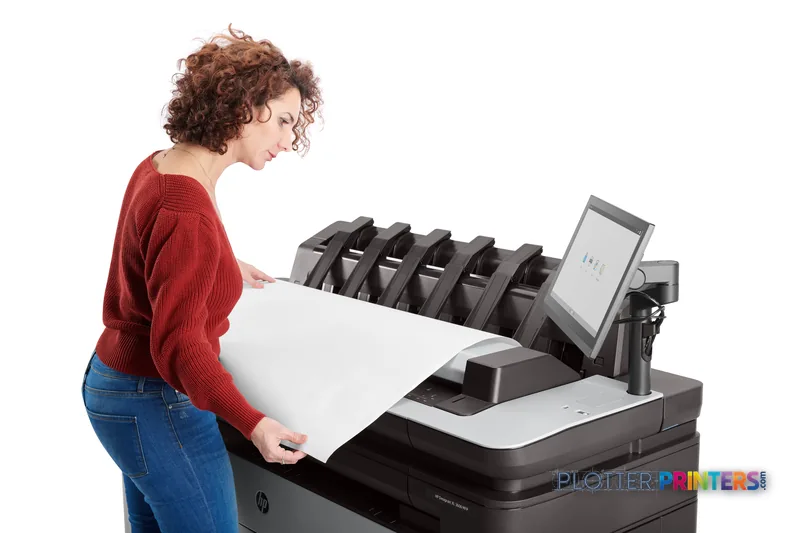 Woman retrieving a large-format print from HP DesignJet XL 3600dr 36-in Multifunction Printer in lifestyle setting