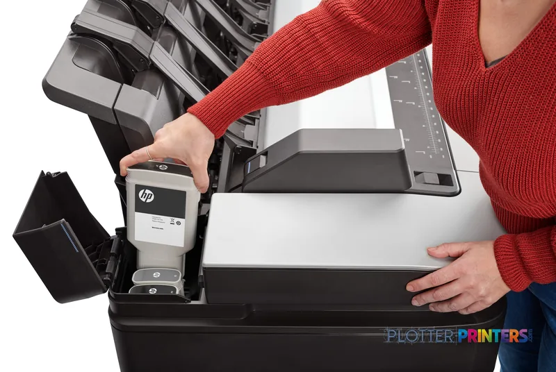 HP DesignJet XL 3600dr 36-in Multifunction Printer lifestyle image showing a person accessing the ink cartridge system