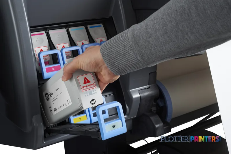 HP Latex 375 Printer Europe lifestyle image showing a person replacing an ink cartridge in the grey printer