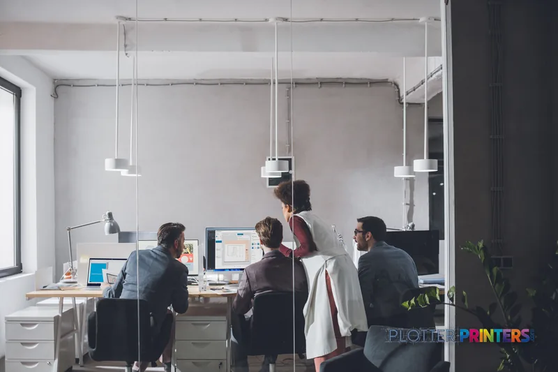 HP DesignJet T2600 36-in PostScript Multifunction Printer in modern office lifestyle setting with team collaborating