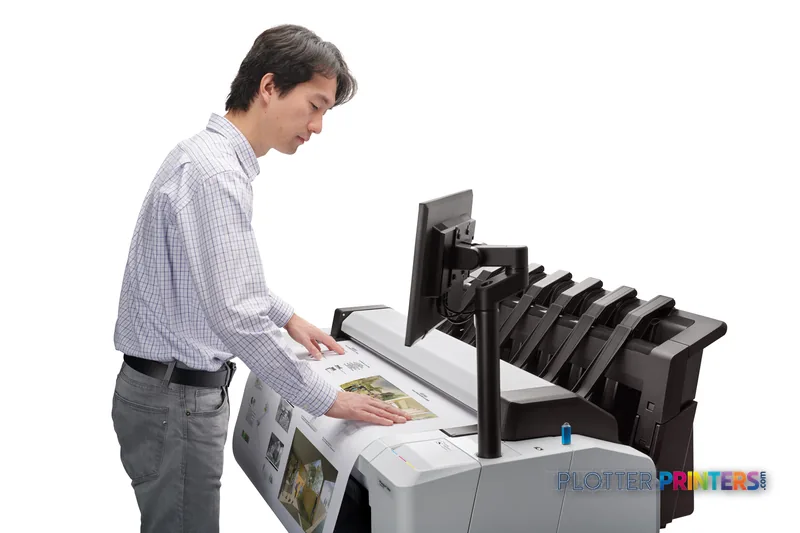 Man using HP DesignJet T2600 36-in PostScript Multifunction Printer in lifestyle setting, retrieving printed output