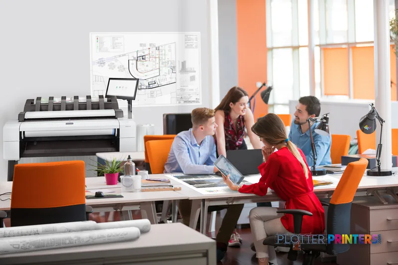 HP DesignJet T2600 36-in PostScript Multifunction Printer in a modern office with team reviewing architectural plans