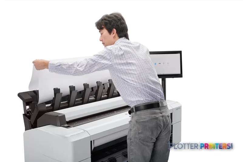 Man removing a large-format print from HP DesignJet T2600 36-in PostScript Multifunction Printer in lifestyle setting