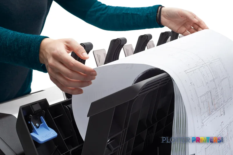 HP DesignJet T2600 36-in PostScript Multifunction Printer lifestyle image showing hands removing a large-format printed arch…