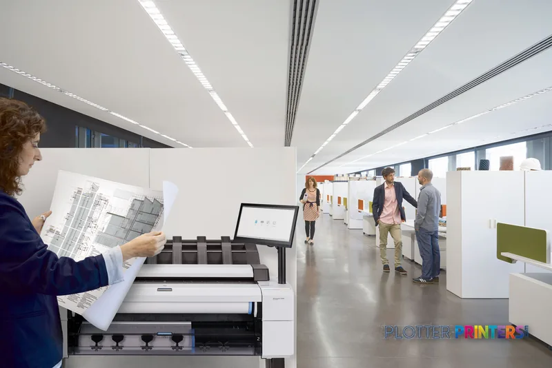 HP DesignJet T2600 36-in printer in a modern office environment with a person holding large-format prints