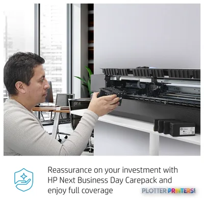 HP DesignJet Studio 36-in Printer with user accessing the paper feed mechanism in an office setting