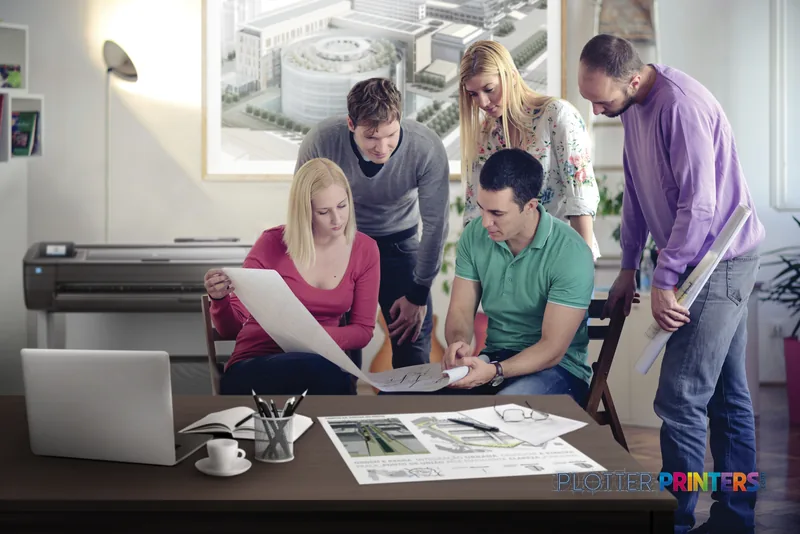 HP DesignJet T730 36-in Printer lifestyle image showing a team reviewing large-format prints in an office