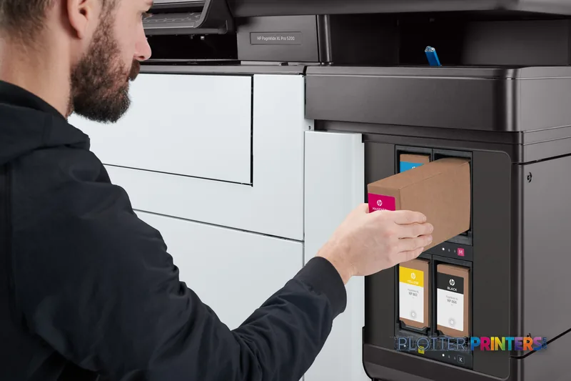 Man replacing magenta ink cartridge in HP PageWide XL Pro 5200 printer lifestyle view