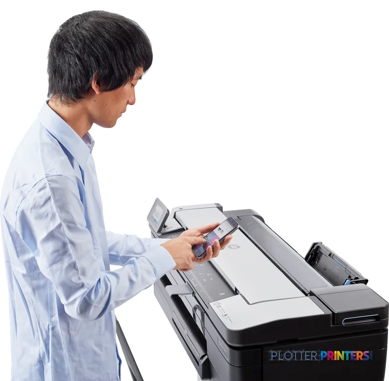 Man in blue shirt using HP DesignJet T830 36-in multifunction printer with touchscreen display