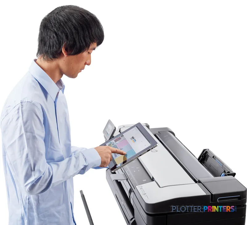 Man in blue shirt using the touchscreen on an HP DesignJet T830 36-in multifunction printer in a lifestyle setting