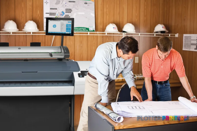 HP Designjet T790 44" large format printer lifestyle image showing two professionals reviewing printed architectural plans i…