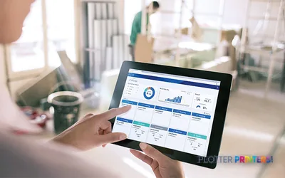 Person holding tablet displaying business dashboard in office environment