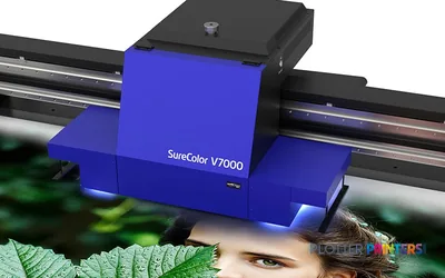 Epson SureColor SC-V7000 large-format printer product image showing blue and black inkjet printer with feed rollers