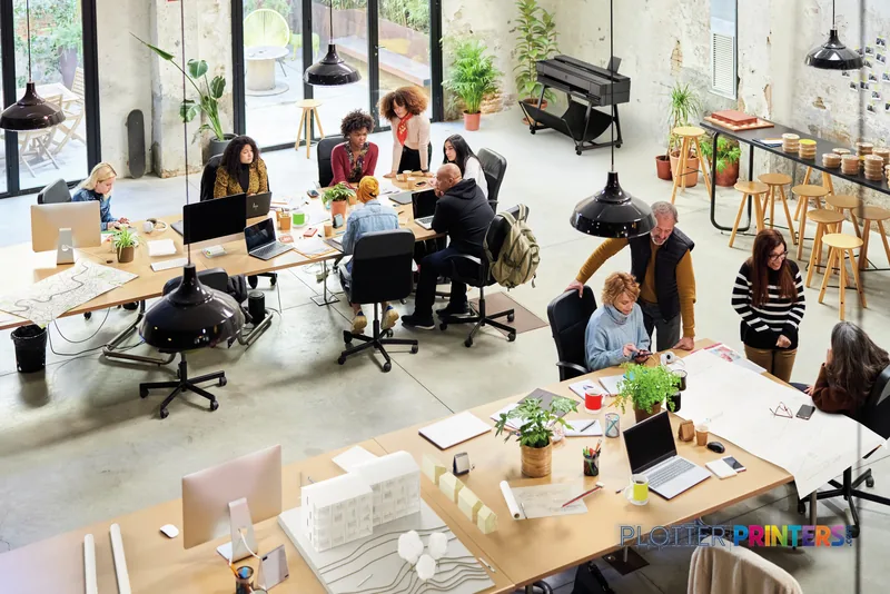 HP DesignJet T850 36-in Printer in a bright creative office workspace with teams collaborating