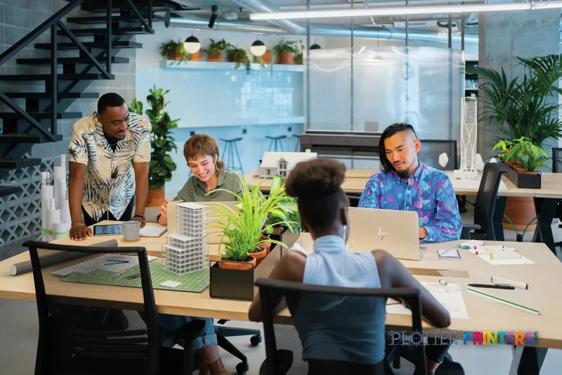 HP DesignJet T850 36-in Printer lifestyle image showing a modern office workspace with team members collaborating