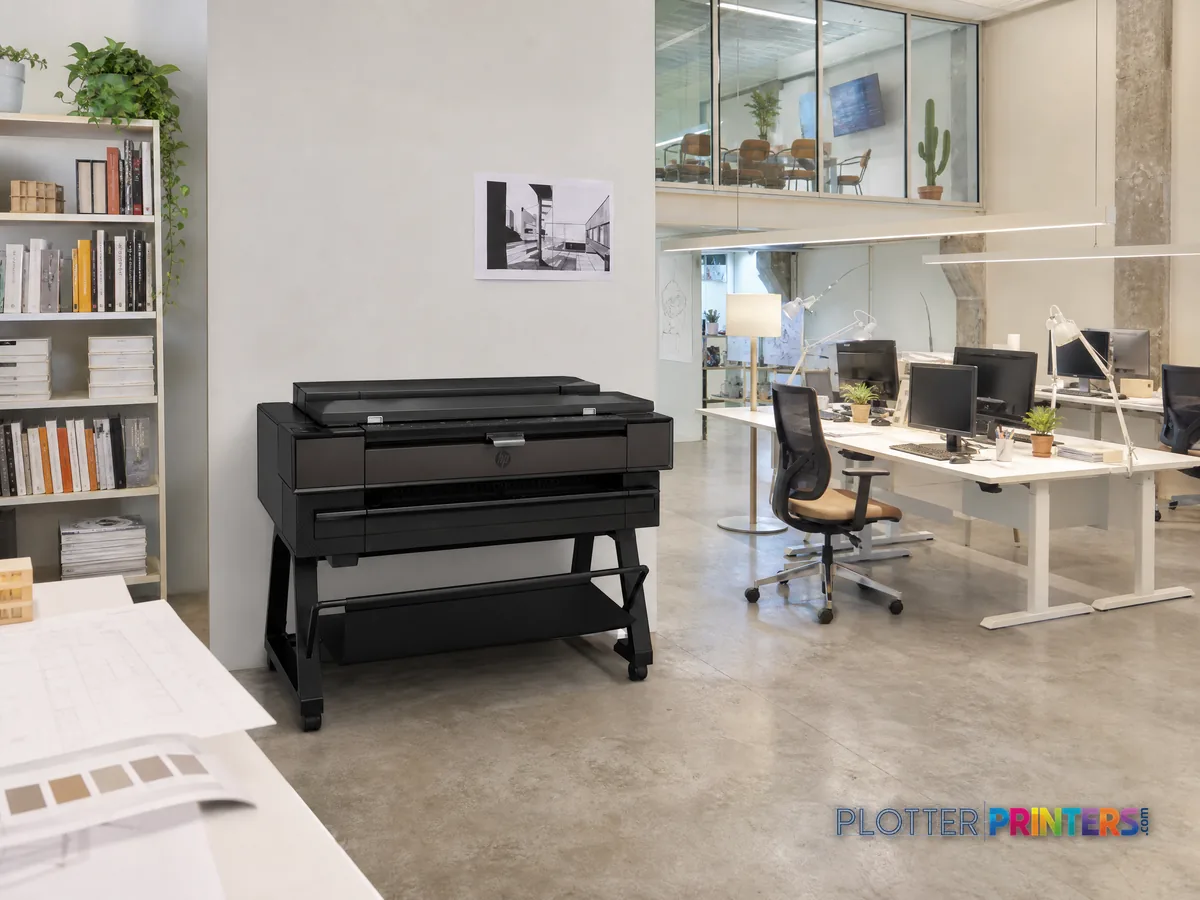 HP DesignJet T850 36-in MFP in a bright architecture studio, printing a large floor plan (staged scene from manufacturer product photography)